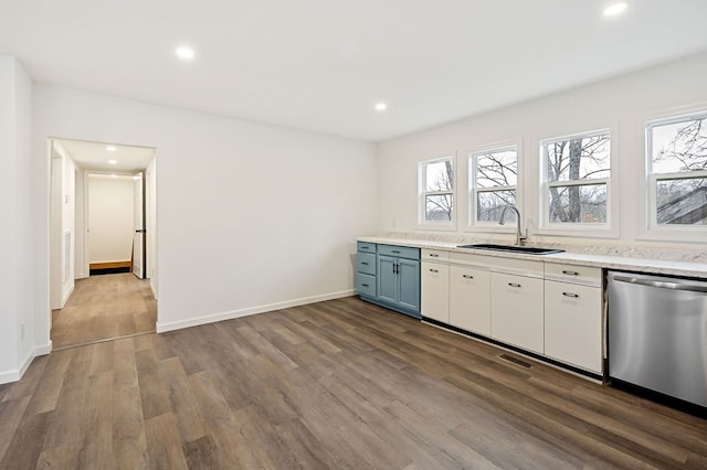 kitchen with dishwasher, light wood-type flooring, white cabinets, and sink