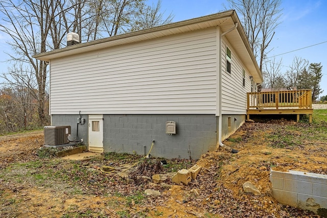 view of side of property featuring central air condition unit and a wooden deck