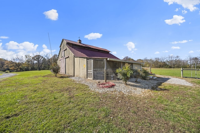 exterior space featuring a lawn and an outdoor structure