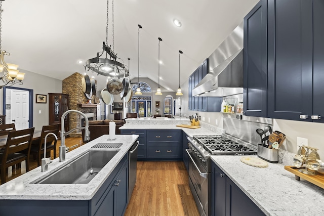 kitchen with hardwood / wood-style floors, sink, vaulted ceiling, wall chimney exhaust hood, and stainless steel appliances