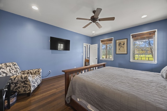 bedroom with ceiling fan and dark hardwood / wood-style flooring