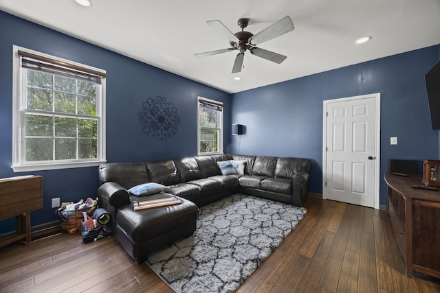 living room with dark hardwood / wood-style floors and ceiling fan