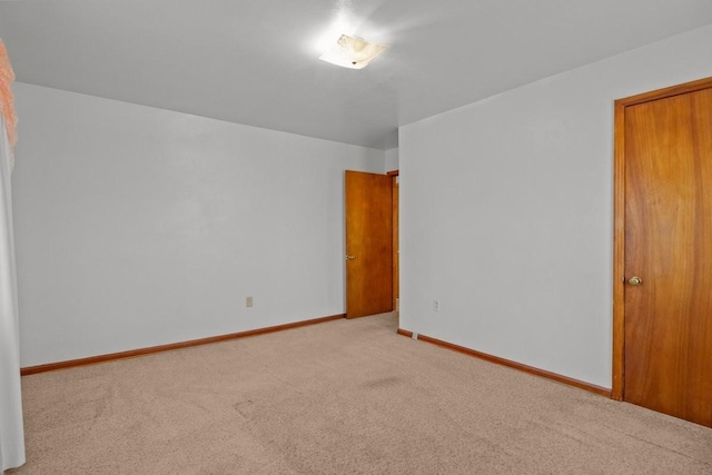 spare room with light carpet