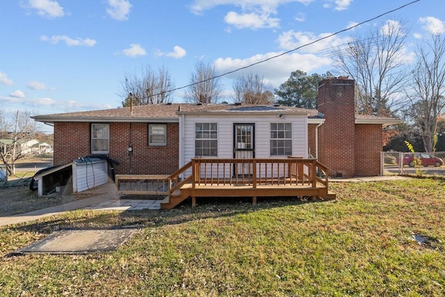 back of property with a deck and a yard