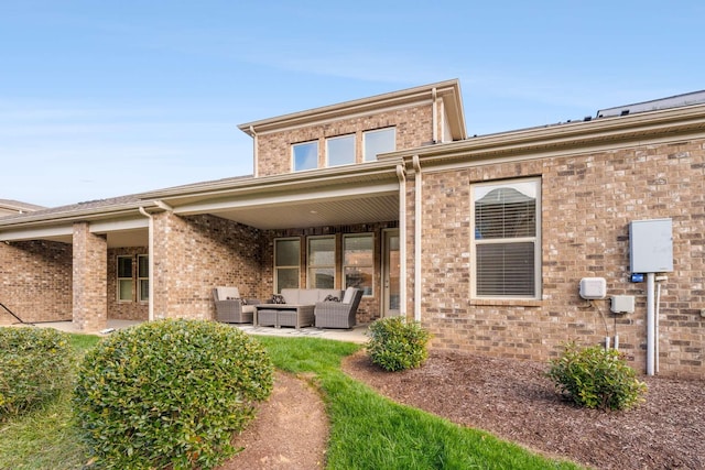 back of house featuring outdoor lounge area, central air condition unit, and a patio