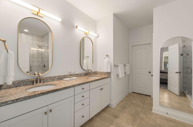 bathroom with tile patterned flooring, vanity, and a shower with door