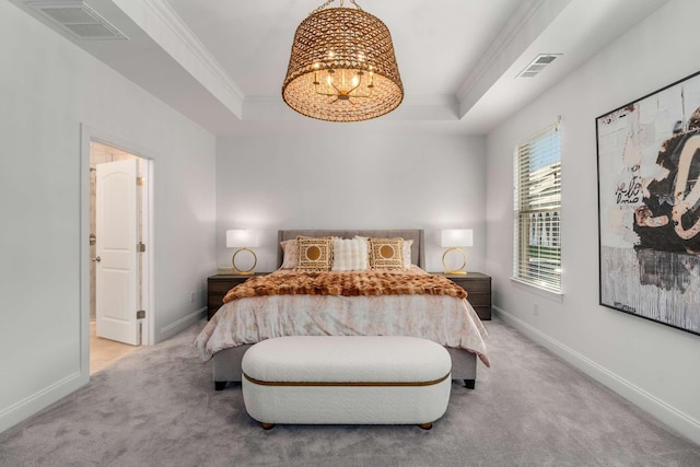 carpeted bedroom featuring a tray ceiling, a chandelier, and ornamental molding