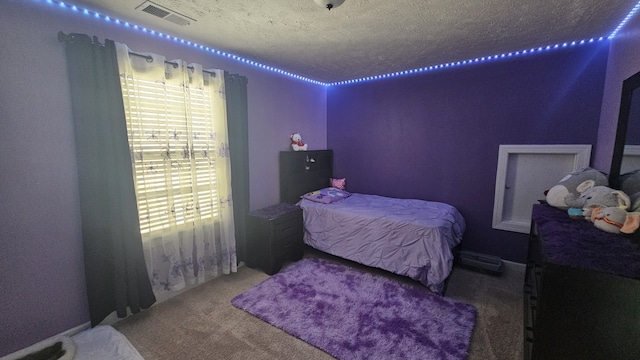 bedroom with carpet flooring and a textured ceiling