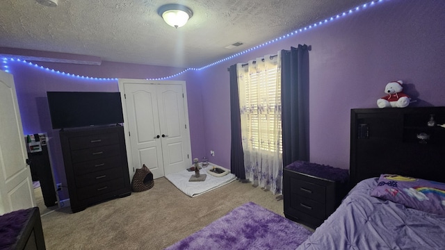 carpeted bedroom with a textured ceiling