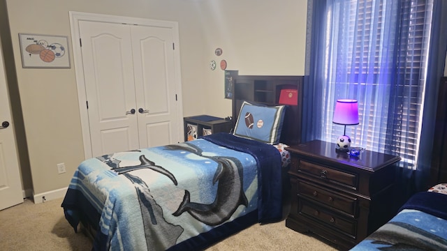 carpeted bedroom with multiple windows and a closet