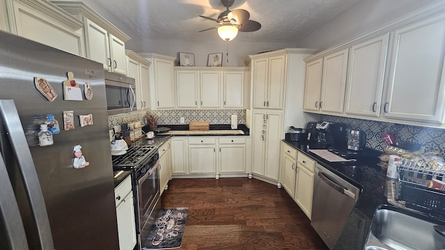 kitchen featuring ceiling fan, dark wood-type flooring, tasteful backsplash, a textured ceiling, and appliances with stainless steel finishes