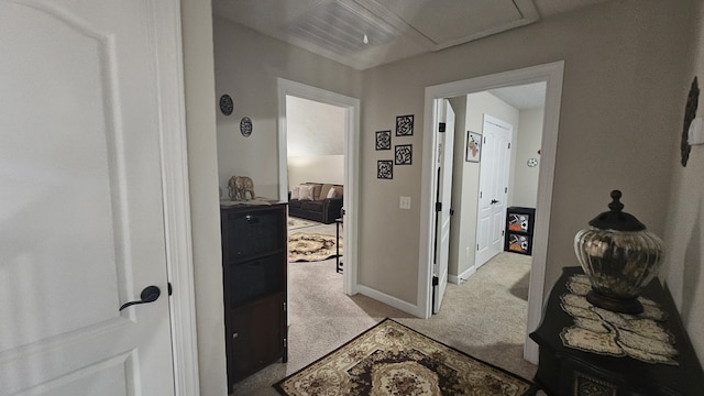 corridor featuring light colored carpet