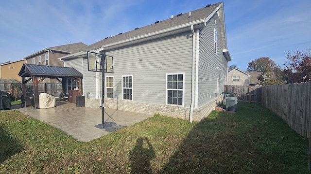 rear view of house with a gazebo, a yard, a patio, and cooling unit