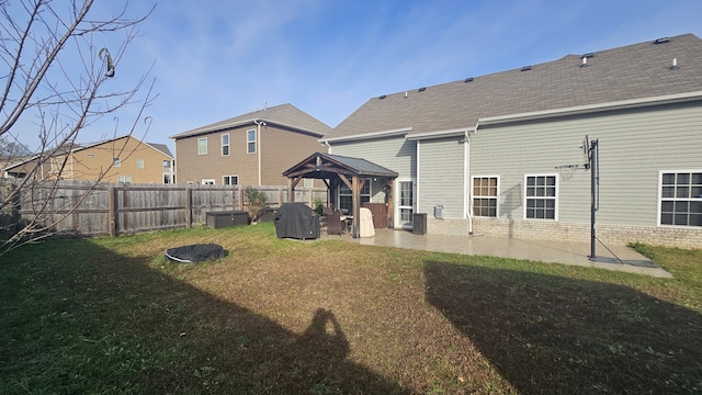 back of property with a gazebo and a yard