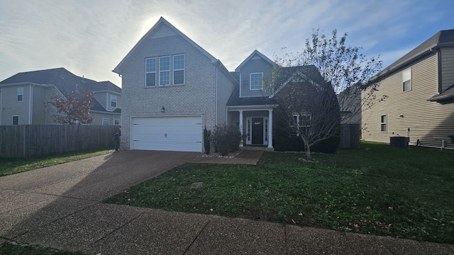 view of property featuring central AC, a front lawn, and a garage