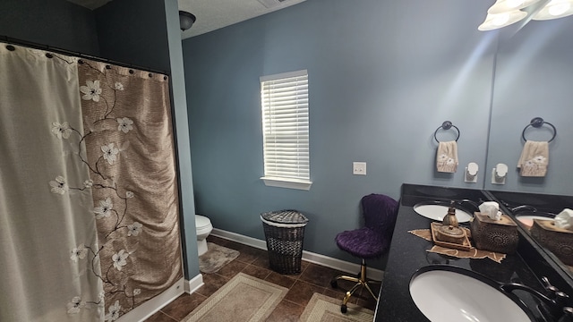 bathroom featuring tile patterned floors, a textured ceiling, vanity, toilet, and curtained shower