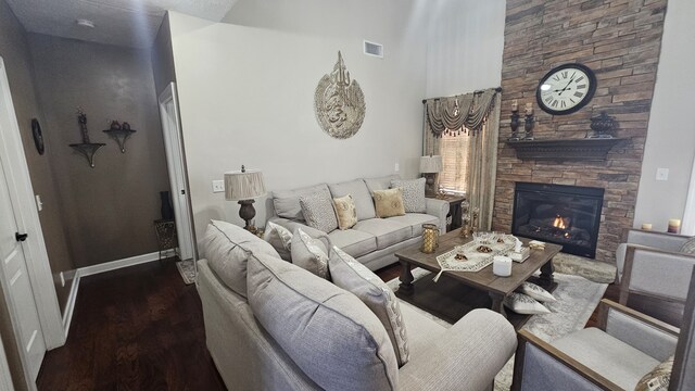 living room with a fireplace and dark hardwood / wood-style floors