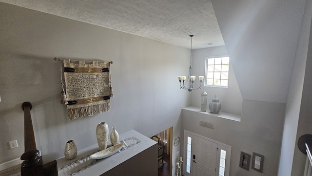 bathroom with a textured ceiling and a chandelier