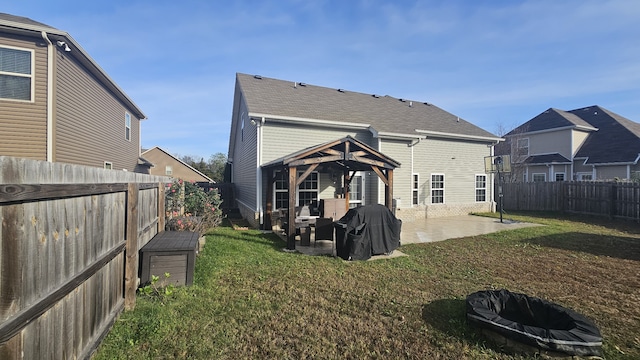 back of property featuring a gazebo, a yard, and a patio