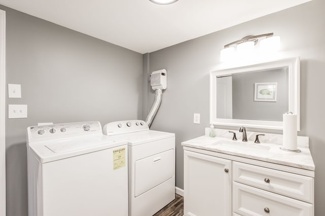 clothes washing area featuring sink, cabinets, dark hardwood / wood-style floors, and independent washer and dryer