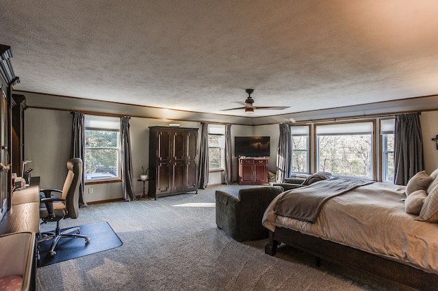 bedroom with ceiling fan, a textured ceiling, and light carpet