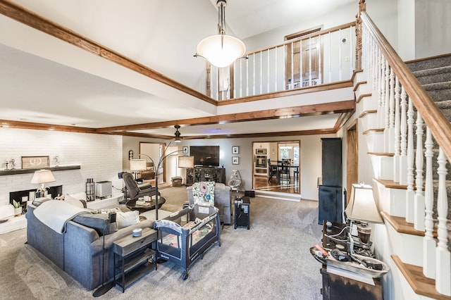 living room featuring carpet flooring, ornamental molding, a fireplace, and brick wall