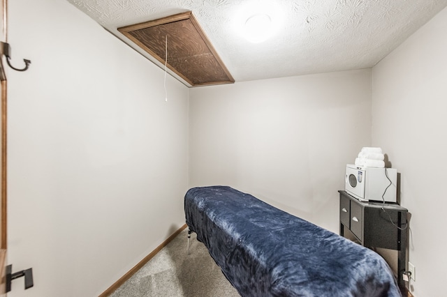 carpeted bedroom with a textured ceiling