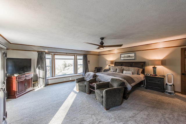 bedroom featuring a textured ceiling, ceiling fan, and light carpet