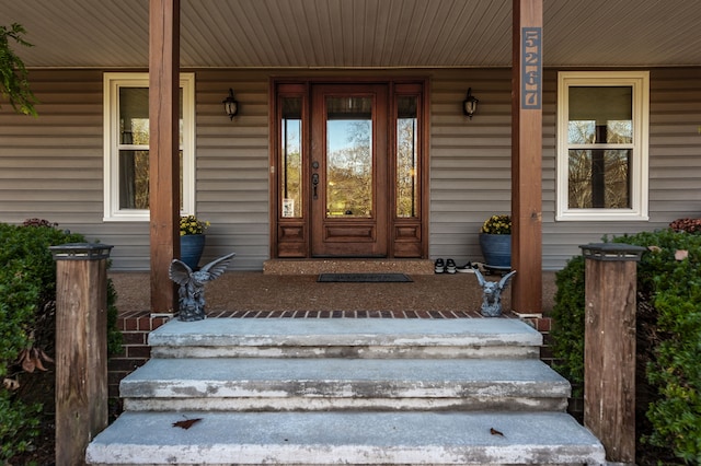 doorway to property featuring covered porch