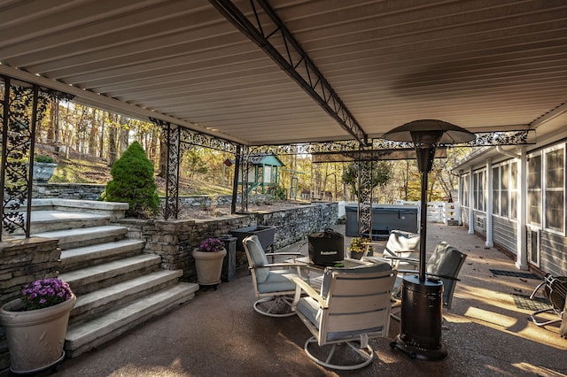 view of patio / terrace with a hot tub