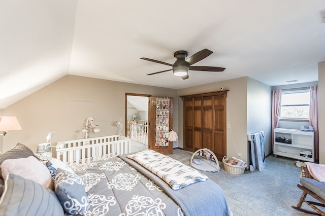 bedroom featuring carpet flooring, vaulted ceiling, and ceiling fan