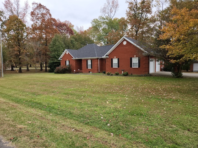 view of front of house with a front yard and a garage