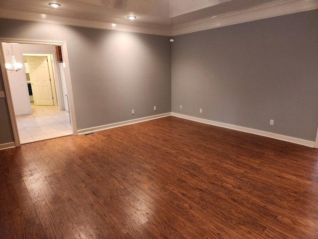 unfurnished room featuring ornamental molding and light hardwood / wood-style flooring