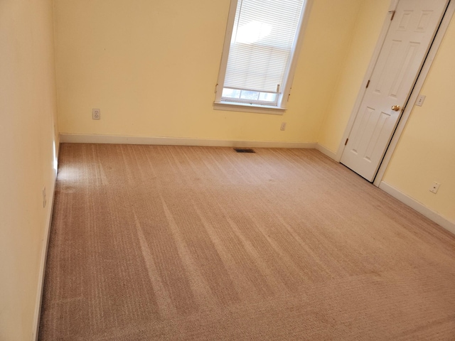 spare room with light colored carpet