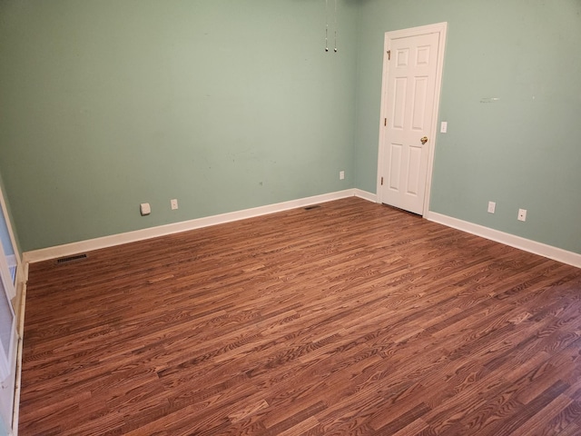 spare room with dark hardwood / wood-style flooring