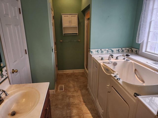 bathroom with vanity and a tub