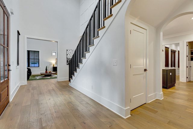 entryway featuring light hardwood / wood-style flooring and crown molding