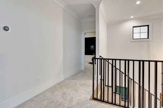 corridor featuring light colored carpet and ornamental molding