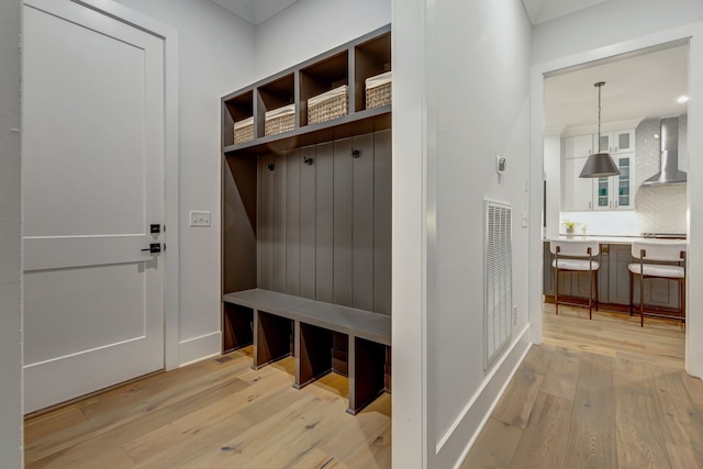 mudroom with hardwood / wood-style floors