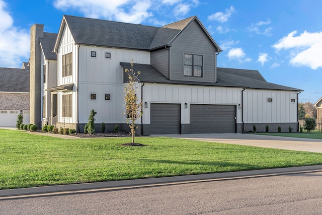 modern farmhouse style home with a front lawn and a garage