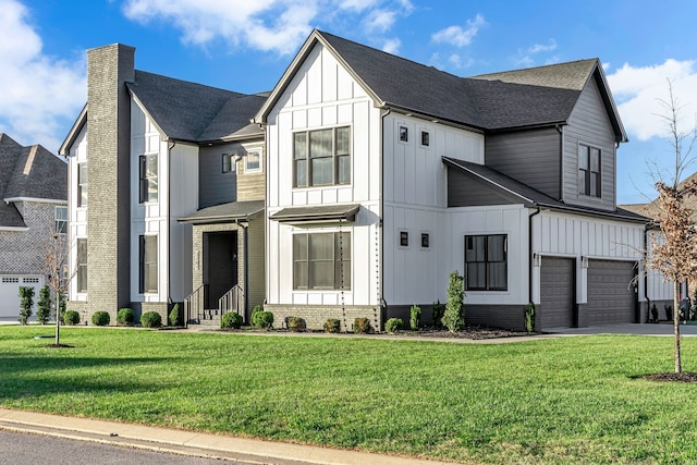 view of front of house with a garage and a front yard