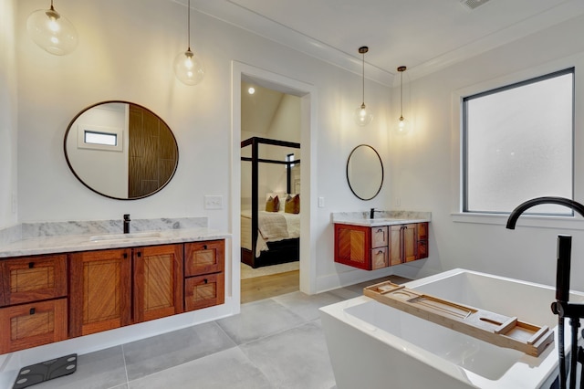 bathroom featuring a bathtub, vanity, concrete floors, and ornamental molding