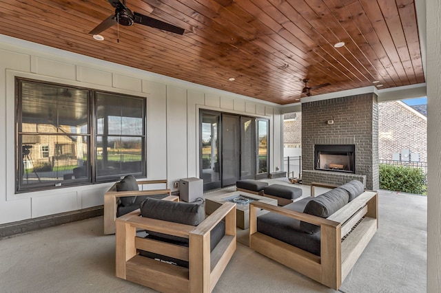 view of patio featuring an outdoor living space with a fireplace and ceiling fan