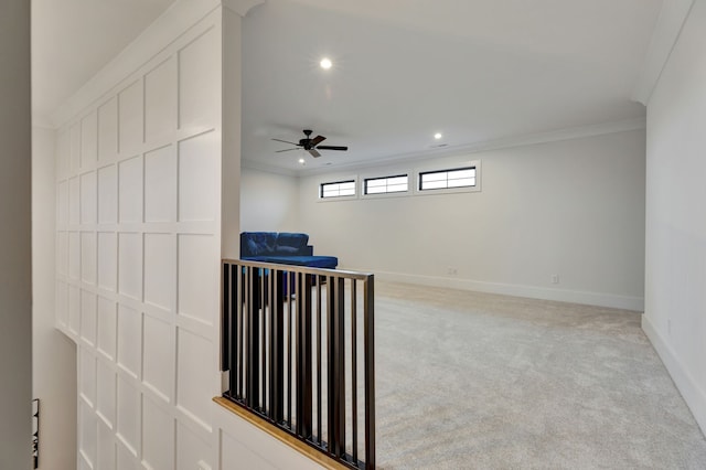 interior space with ceiling fan and ornamental molding