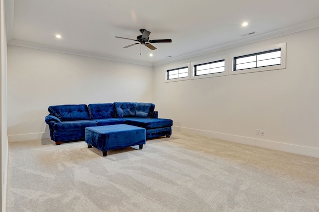 carpeted living room featuring ceiling fan and ornamental molding