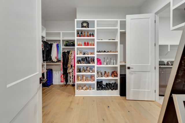 walk in closet featuring washer / dryer and hardwood / wood-style flooring