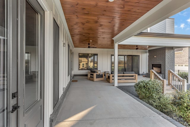 view of patio / terrace with an outdoor brick fireplace and ceiling fan