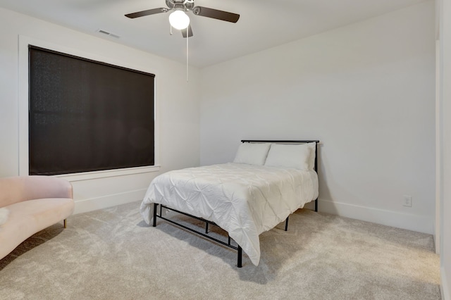 bedroom featuring light colored carpet and ceiling fan