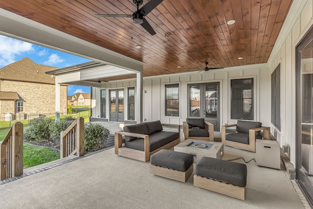 view of patio / terrace featuring ceiling fan and an outdoor living space with a fire pit