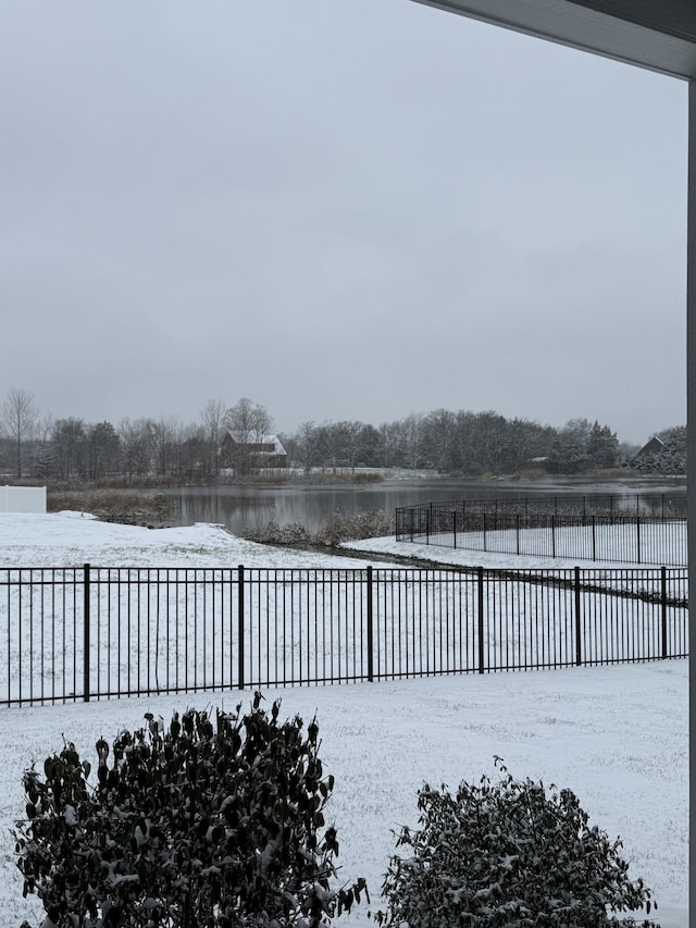 yard layered in snow with a water view